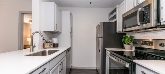 an empty kitchen with white cabinets and stainless steel appliances at Briarcliff Apartments, Atlanta, GA, 30329