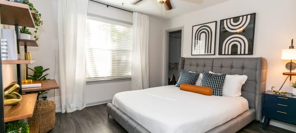 a bedroom with a large bed and a ceiling fan at Briarcliff Apartments, Atlanta