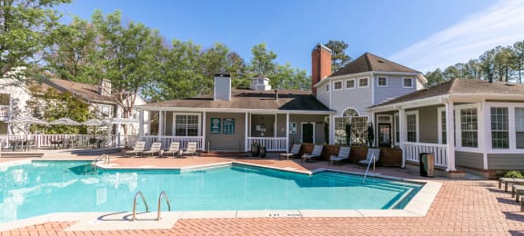 a large swimming pool with a house in the background at Briarcliff Apartments, Georgia