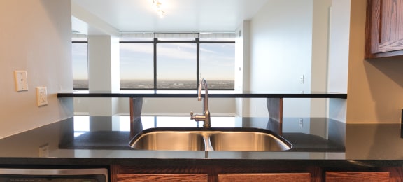 a kitchen with a sink and a window at Apartments at Denver Place, Denver, 80202