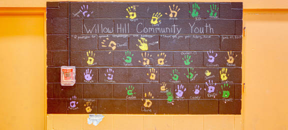 a chalkboard calendar on the wall of a school with the words allied community at Willow Hill Apartments, Justice, 60458