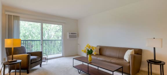a living room with a couch and a chair and a table at Willow Hill Apartments, Illinois, 60458