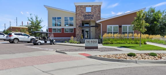 a building with a golf cart parked in front of it at Ridge at Thornton Station Apartments, Colorado, 80229