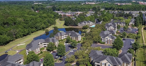 an aerial view of a neighborhood with houses and a pond at Ashford Green, NC 28262