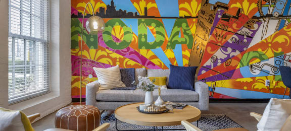 a living room with a colorful mural on the wall at Highland Mill Lofts, North Carolina, 28205