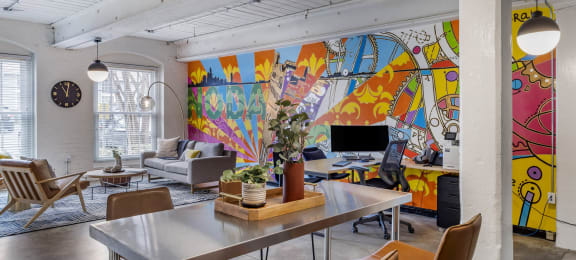 a living room with a table and chairs and a mural on the wall at Highland Mill Lofts, Charlotte, North Carolina