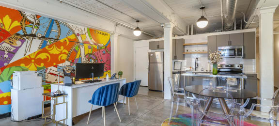 a living room with a kitchen and a table and chairs at Highland Mill Lofts, Charlotte, 28205