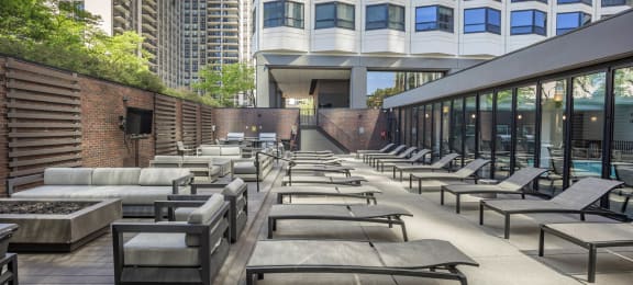 a row of lounge chairs on a patio next to a building at North Harbor Tower, Illinois, 60601