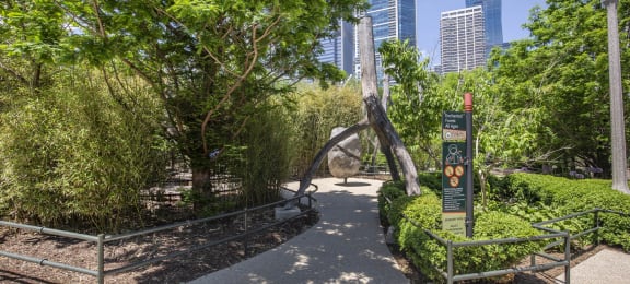 a park with trees and a sculpture in the middle at North Harbor Tower, Chicago, Illinois 60601