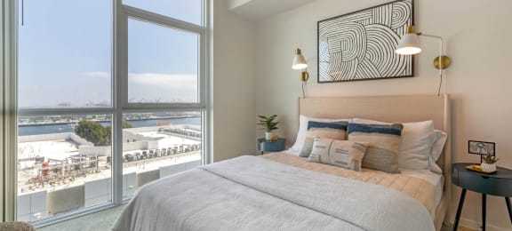 a bedroom with a bed and a large window  at Vue, San Pedro, California