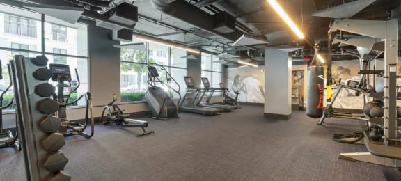 a gym with cardio equipment and windows in a building  at Vue, San Pedro, CA, 90731