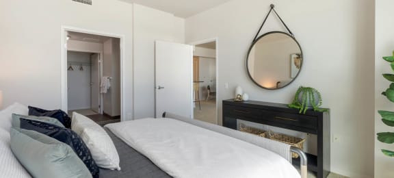 a bedroom with a bed and a mirror above it  at Vue, San Pedro, 90731