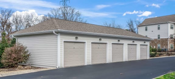 a garage with white doors and a roof