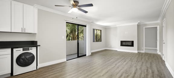 Sherman Oaks CA Apartments for Rent - Brody Terrace - Spacious Living Room with Wood-Style Floors, an Interior Fireplace, Ceiling Fan & Attached Private Patio