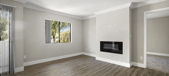 Apartments in Sherman Oaks CA - Open Space Living Room Showing Plenty of Natural Light With Hardwood Floor Featuring a Fireplace