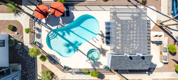 an aerial view of a building with a blue pool in the middle of it