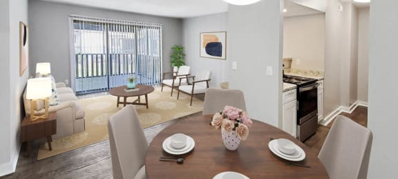 a dining area with a wooden table and chairs and a kitchen in the background at Planters Trace, Charleston, 29414