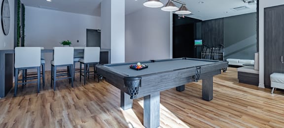 Games room featuring billiards table and additional seating at La Voile Pointe-Claire apartments in Pointe-Claire, Quebec