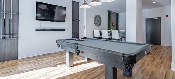 Games room featuring billiards table and luxury vinyl flooring at La Voile Pointe-Claire apartments in Pointe-Claire, Quebec