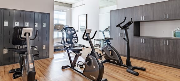 Fully equipped fitness centre and yoga studio at La Voile Pointe-Claire apartments in Pointe-Claire, Quebec