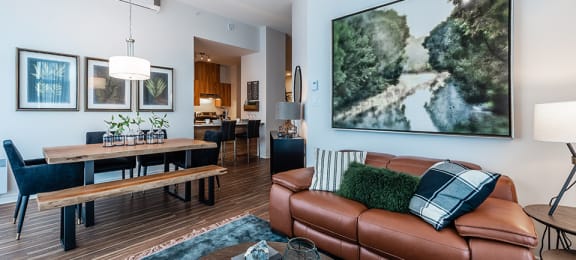 Living and dining room with luxury flooring and modern finishes at La Voile Pointe-Claire apartments in Point-Claire, Quebec