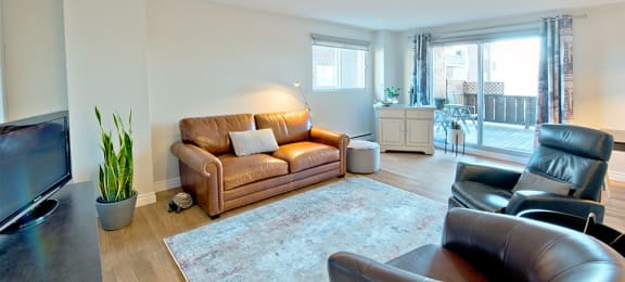 Les Jardins Hauterive in Sherbrooke, QC spacious living room with access to private balcony