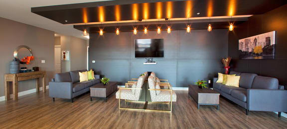 Penthouse resident's lounge with lounge seating and flat screen TV located in Building A at Trio on Belmont in Kitchener, ON