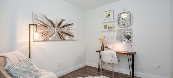 Den, set up as a home office with a desk and chair, in a 2 bed + den 2 bath variation E in building A at Trio on Belmont in Kitchener, ON