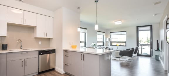 Open floor plan kitchen and living room in a 2 bed + den 2 bath variation E in building A at Trio on Belmont in Kitchener, ON