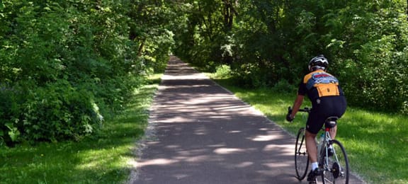 a person riding a bike down a path