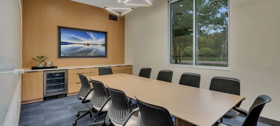 a conference room with a large window and a table and chairs