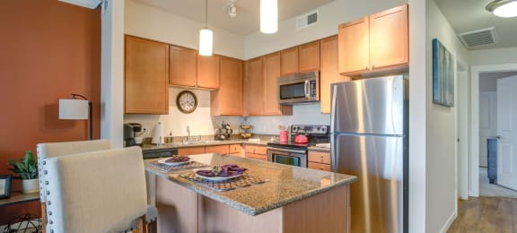a kitchen with stainless steel appliances and a granite counter top