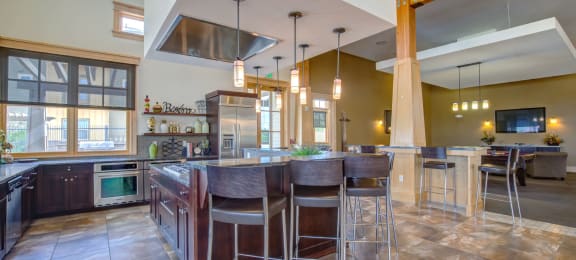 a large kitchen with a center island and bar stools