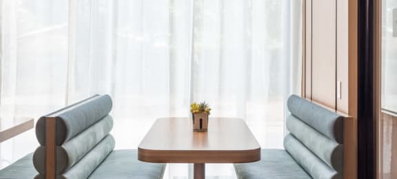 a table and two chairs in front of a window