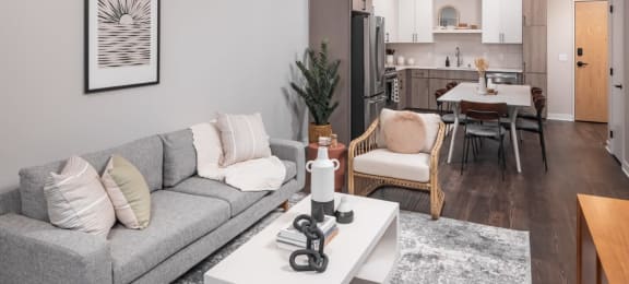 a living room with a gray couch and a white coffee table
