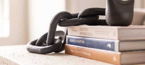 a stack of books on a table with a lock on top of them