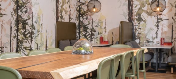 a dining room with a wooden table and green chairs