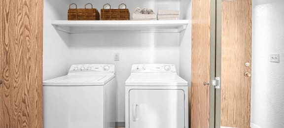 a small laundry room with two washes and a dryer