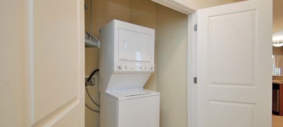 Stacked washer and dryer with door
