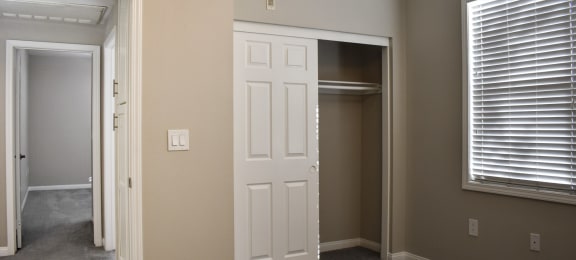 view of bedroom closet and hallway leading to second bedroom