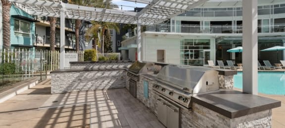 a patio with a grill and a swimming pool