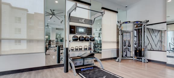 a home gym with exercise equipment and glass doors