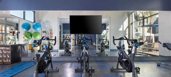 a spacious fitness center with treadmills and exercise bikes