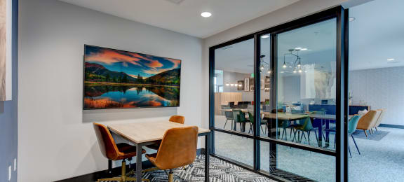 a conference room with glass doors and a table with chairs