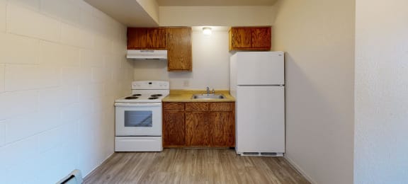 a small kitchen with white appliances and wooden cabinets
