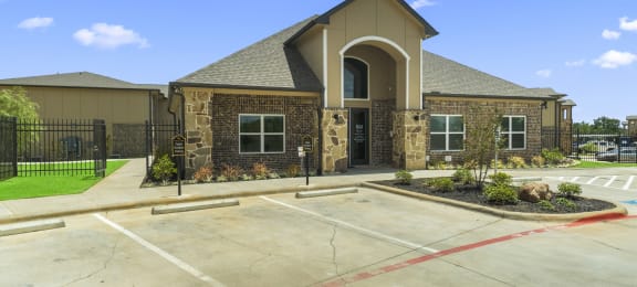 the exterior of a building with a parking lot and a driveway