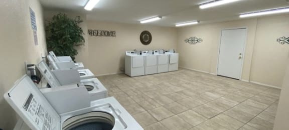 large on-site laundry center with washers and dryers