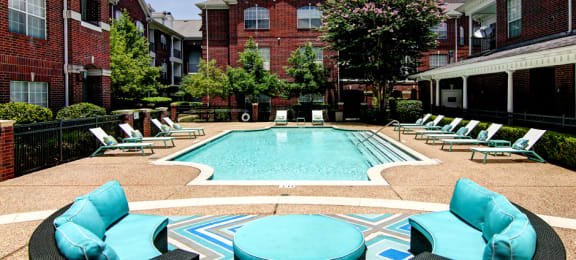 Luxury swimming pool with relaxing sundeck at Tuscany Apartments in Houston.