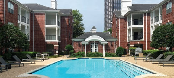 Luxury swimming pool with large sundeck at Tuscany Gate Apartments in Houston.