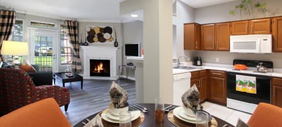 Luxury apartments with wood grain plank floors, dining room, u-shaped kitchen, 9-foot ceilings, and woodburning fireplace at Lenox Village Apartments in Lincoln, Nebraska